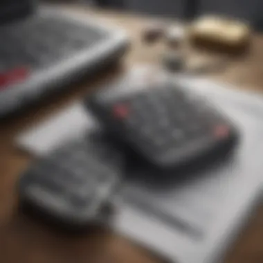 Close-up of a finance calculator and car keys on a table